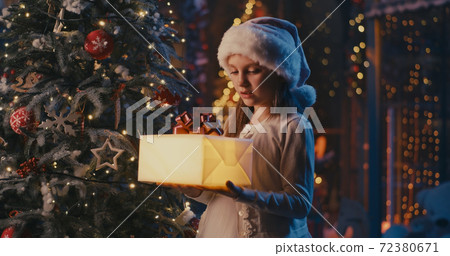Crop Santa Claus giving present to cute girl 72380671