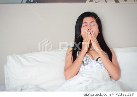 young woman yawning before go to sleep in bedroom young woman yawning before go to sleep in bedroom 72382157