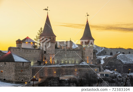 Kamianets-Podilskyi fortress on a winter night 72383104