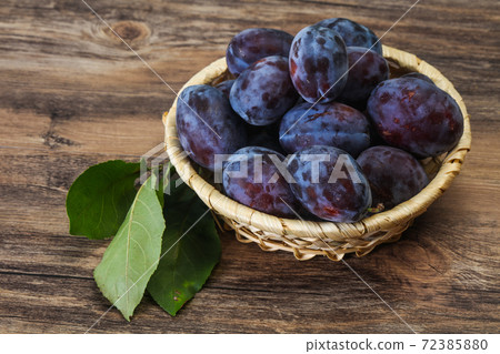 Ripe plum heap in the basket Ripe plum heap in the basket 72385880
