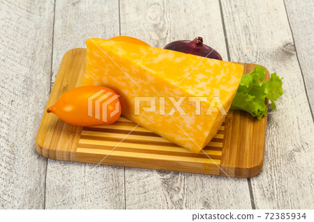 Marble cheese  triangle over wooden 72385934