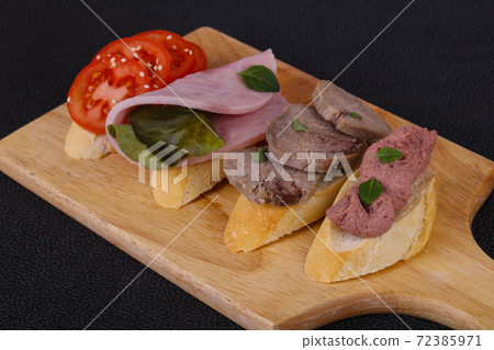 Bruschetta with tomato, ham and tongue Bruschetta with tomato, ham and tongue 72385971