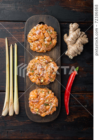 Quick asian raw fishcakes, on old wooden table, top view Quick asian raw fishcakes, on old wooden table, top view 72386868