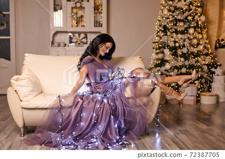 beautiful pretty woman wearing elegant dress posing in christmas interior beautiful pretty woman wearing elegant dress posing in christmas interior 72387705