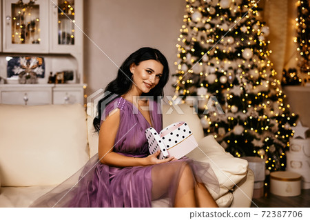 beautiful pretty woman wearing elegant dress with christmas gift beautiful pretty woman wearing elegant dress with christmas gift 72387706