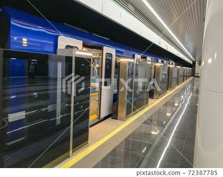 Blue train standing with an open sliding mechanical door at a train station platform. Last stop. Wagons of subway in underground. Rapid transport. High-speed electric train 72387785