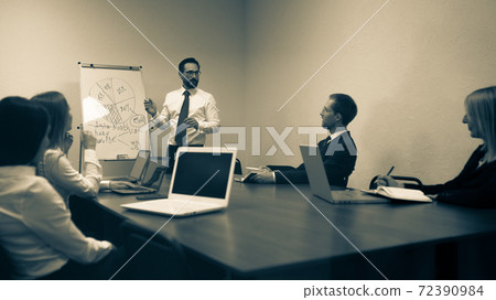 Toned image of supervisor showing planning concept to team sitting in the meeting or conference room. Business people meeting at the office to share an idea. 16x9 format 72390984