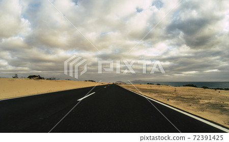 Ground beautiful view of long way straight asphalt road and blue clouds sky in background - concept of drive and travel with vehicle - beauty nature park outdoor place and way Ground beautiful view of long way straight asphalt road and blue clouds sky in background - concept of drive and travel with vehicle - beauty nature park outdoor place and way 72391425