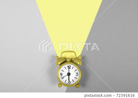 Alarm clock on gray and yellow background. 72391616