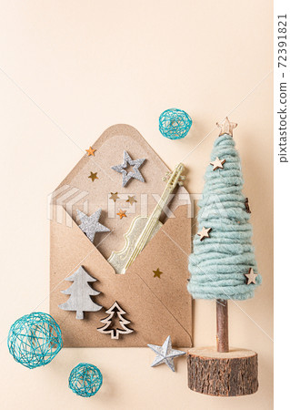 Brown envelop with christmas decorations and gifts. Brown envelop with christmas decorations and gifts. 72391821