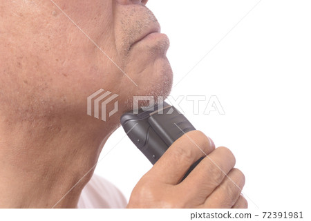 Japanese senior man shaving with an electric shaver Japanese senior man shaving with an electric shaver 72391981