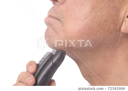 Japanese senior man shaving with an electric shaver Japanese senior man shaving with an electric shaver 72391984
