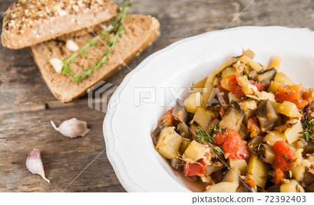 Vegetable stew with Italian herbs in a rustic style Vegetable stew with Italian herbs in a rustic style 72392403