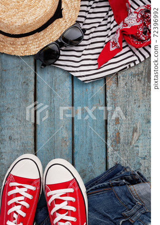 Still life of various items for recreation, clothing, hat, sneakers, camera, passport, telephone Still life of various items for recreation, clothing, hat, sneakers, camera, passport, telephone 72396992