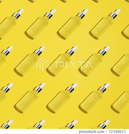Serum bottle pattern on yellow background 72398611