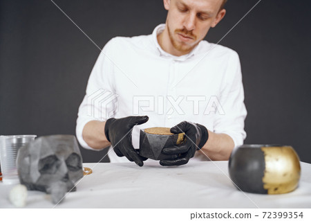 Man in a white shirt works with a cement 72399354