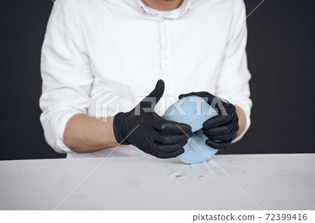 Man in a white shirt works with a cement Man in a white shirt works with a cement 72399416