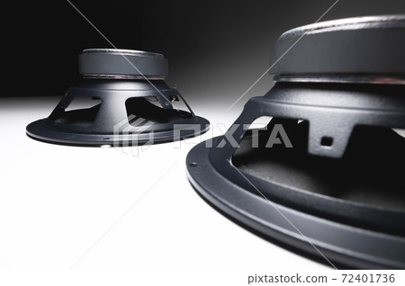 Two new car speakers on a white background in contrasting light. Wide angle audio background 72401736