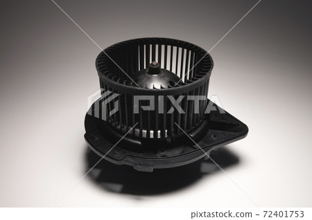 Heater motor. A spare part for an automobile heating system on a black-gray gradient background. Low key high contrast Heater motor. A spare part for an automobile heating system on a black-gray gradient background. Low key high contrast 72401753