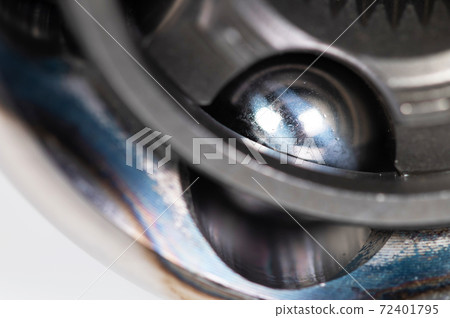 Close-up of a new CV joint on a gray background. Car suspension parts 72401795