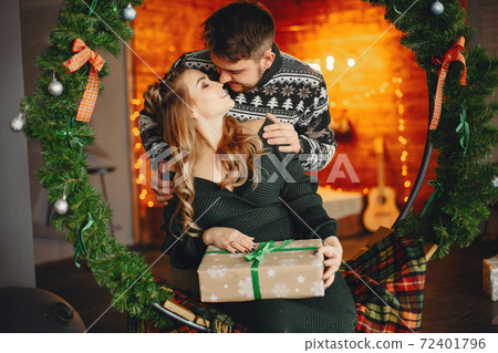 Cute family sitting near Christmas tree 72401796