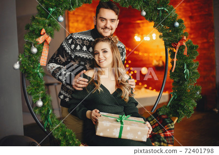 Cute family sitting near Christmas tree Cute family sitting near Christmas tree 72401798
