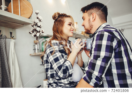 Cute family sitting in the kitchen Cute family sitting in the kitchen 72401806