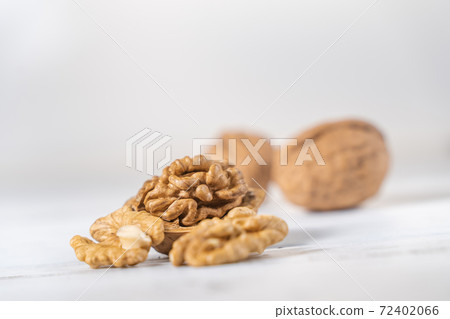 Walnuts kernels on white wooden desk, stock photo Walnuts kernels on white wooden desk, stock photo 72402066