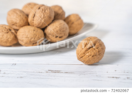 Walnuts kernels on white wooden desk, stock photo 72402067