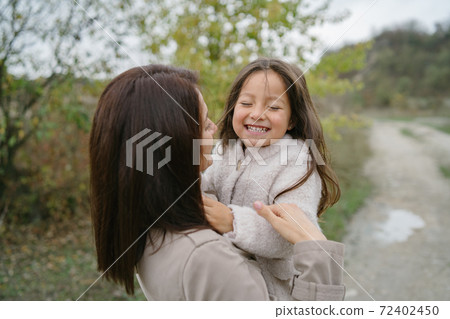 Mother with daughter playing in a career 72402450