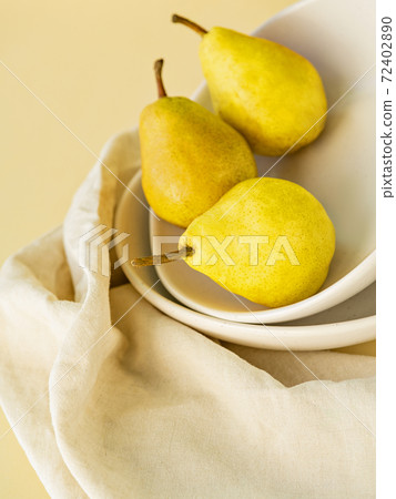 Still life of three illuminating yellow pears. Still life of three illuminating yellow pears. 72402890