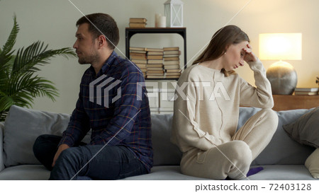 Angry couple sit separate on couch ignore avoid talking after family fight misunderstanding. Unhappy spouses man and woman think of divorce or breakup Angry couple sit separate on couch ignore avoid talking after family fight misunderstanding. Unhappy spouses man and woman think of divorce or breakup 72403128