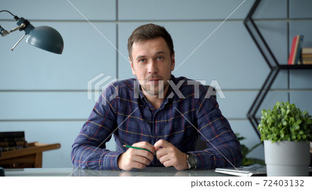 Portrait man looking at speaking at camera having video call from home Portrait man looking at speaking at camera having video call from home 72403132
