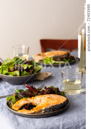 Fried salmon steak with salad 72403990