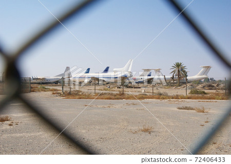 RAS AL KHAIMAH, UNITED ARAB EMIRATES - NOV 09th, 2017: Abandoned Airplane in the desert at Ras Al Khaima airport, shot through fence 72406433
