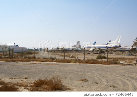 RAS AL KHAIMAH, UNITED ARAB EMIRATES - NOV 09th, 2017: Abandoned Airplane in the desert at Ras Al Khaima airport, shot through fence RAS AL KHAIMAH, UNITED ARAB EMIRATES - NOV 09th, 2017: Abandoned Airplane in the desert at Ras Al Khaima airport, shot through fence 72406445