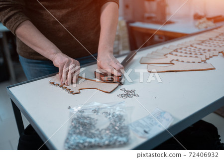 man shaping leather for shoe with knife on factory man shaping leather for shoe with knife on factory 72406932