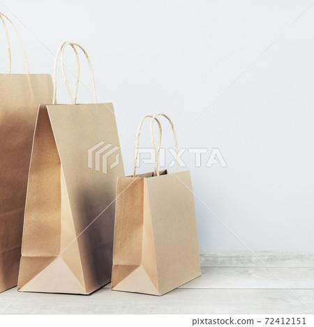 Laptop and paper shopping bags. Packages delivery online orders Laptop and paper shopping bags. Packages delivery online orders 72412151