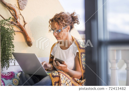 Caucasian woman at home use personal laptop computer outdoor in the terrace - stay home covid-19 quarantine concept for people - smart work with technology out of office 72413482