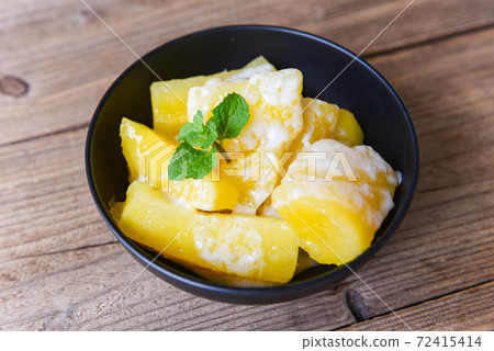 Boiled cassava root dessert with coconut milk Thai food or brazilian food cassava mandioca frita, Other name (manihot esculenta, yuca, manioc, mandioca, Brazilian arrowroot). 72415414