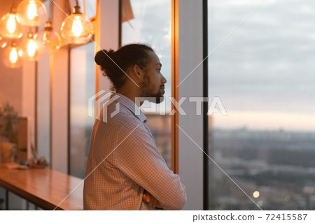 Pensive biracial man look in distance thinking or planning Pensive biracial man look in distance thinking or planning 72415587