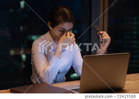 Tired Indian female employee exhausted at workplace Tired Indian female employee exhausted at workplace 72415588