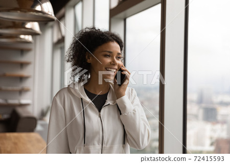 Smiling African American woman talk on smartphone Smiling African American woman talk on smartphone 72415593