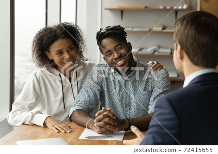Happy biracial couple have meeting male broker Happy biracial couple have meeting male broker 72415655