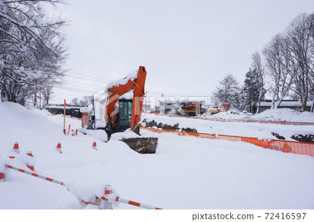 Power shovel at a waterway construction site in winter 72416597