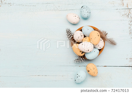Easter craft eggs and branches on blue pastel background with space for text. Flat lay image composition, top view. Easter craft eggs and branches on blue pastel background with space for text. Flat lay image composition, top view. 72417013
