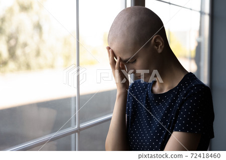 Close up hopeless unhappy sick hairless woman lost in thoughts 72418460