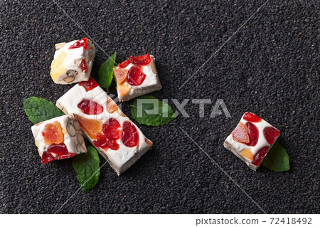 nougat with tropical fruit and peppermint leaves 72418492