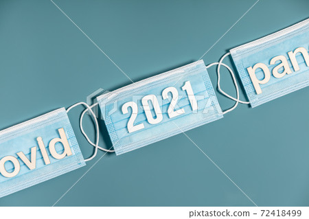Surgical masks with number 2021 and words covid and pandemie 72418499