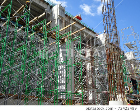 MALACCA, MALAYSIA -MARCH 2, 2020: Construction workers working at height at the construction site. They are supplied with harnesses and other safety equipment to prevent them from having an accident. MALACCA, MALAYSIA -MARCH 2, 2020: Construction workers working at height at the construction site. They are supplied with harnesses and other safety equipment to prevent them from having an accident. 72422489
